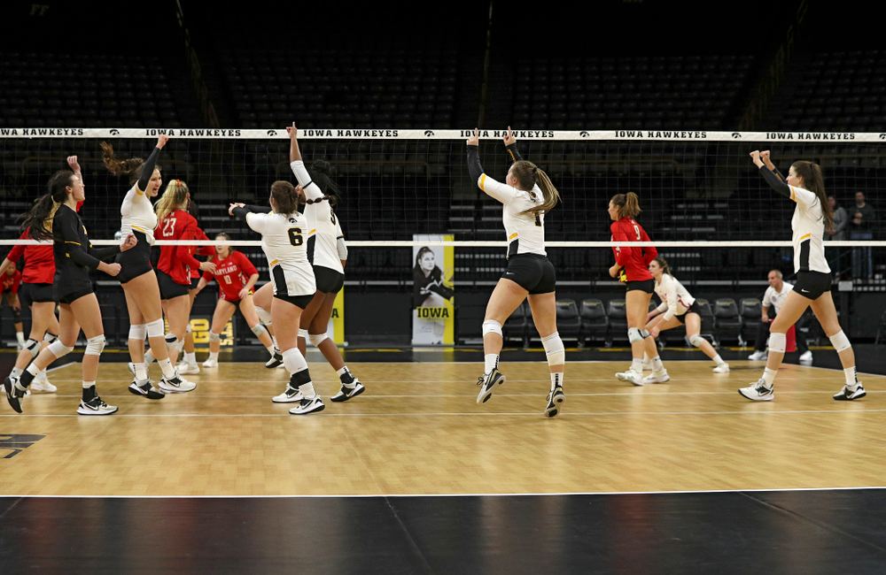 Iowa’s Halle Johnston (4), Blythe Rients (11), Emma Lowes (6), Amiya Jones (9), Joslyn Boyer (1), and Courtney Buzzerio (2) celebrate after winning the fourth set of their match at Carver-Hawkeye Arena in Iowa City on Saturday, Nov 30, 2019. (Stephen Mally/hawkeyesports.com)
