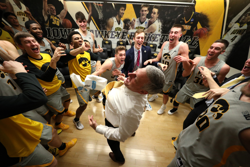 Iowa Hawkeyes assistant coach Kirk Speraw dances with the team following their win against the Iowa State Cyclones in the Iowa Corn Cy-Hawk Series Thursday, December 6, 2018 at Carver-Hawkeye Arena. (Brian Ray/hawkeyesports.com)