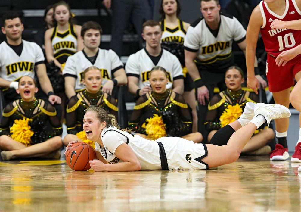 Iowa Hawkeyes guard Kathleen Doyle (22) grabs a loose ball on the floor during the fourth quarter of their game at Carver-Hawkeye Arena in Iowa City on Sunday, January 12, 2020. (Stephen Mally/hawkeyesports.com)