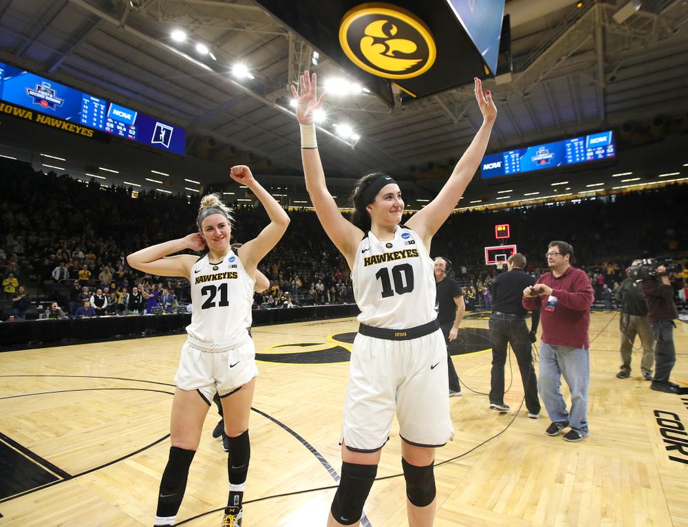 Iowa Hawkeyes forward Hannah Stewart (21) and center Megan Gustafson (10) wave to the crowd after winning their second round game in the 2019 NCAA Women's Basketball Tournament at Carver Hawkeye Arena in Iowa City on Sunday, Mar. 24, 2019. (Stephen Mally for hawkeyesports.com)