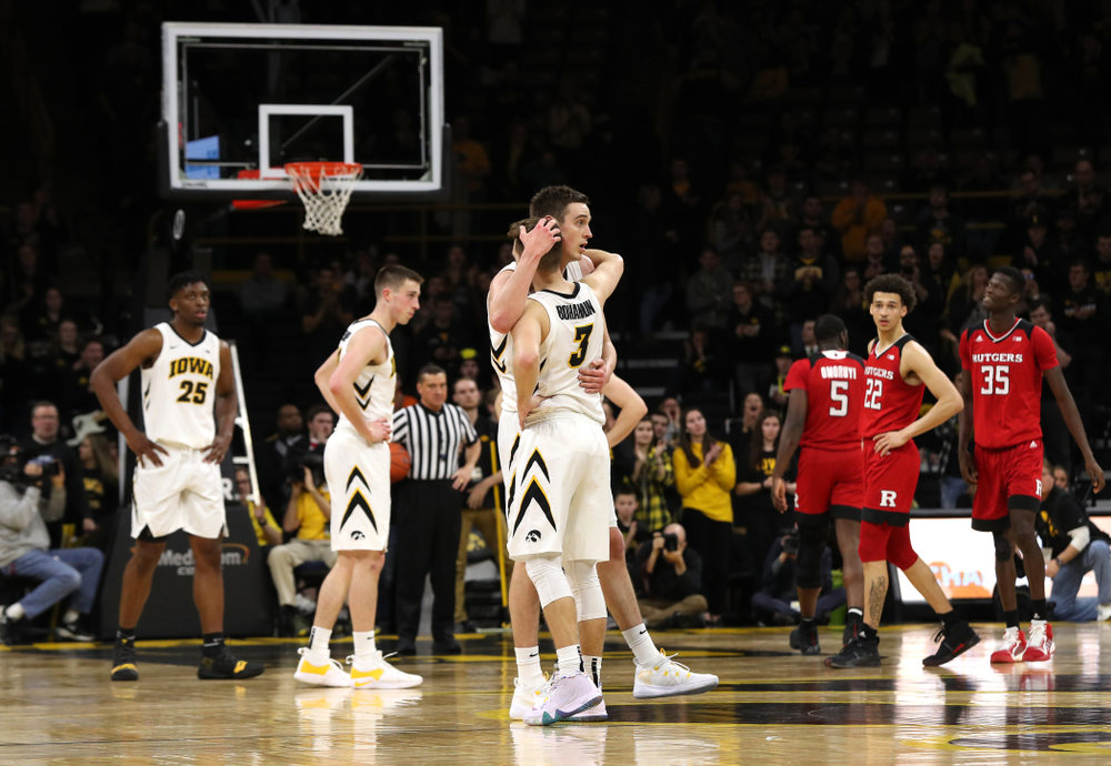 Iowa Hawkeyes forward Nicholas Baer (51) hugs guard Jordan Bohannon (3) as he leaves the court for the final time against the Rutgers Scarlet Knights Saturday, March 2, 2019 at Carver-Hawkeye Arena. (Brian Ray/hawkeyesports.com)