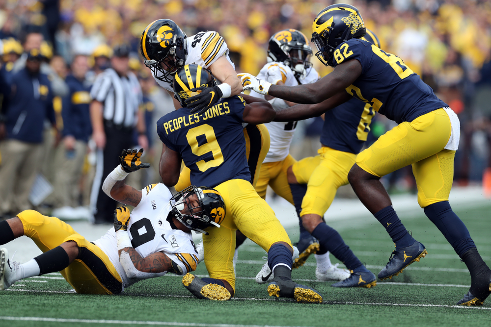 Iowa Hawkeyes linebacker Nick Niemann (49) and defensive back Geno Stone (9) against the Michigan Wolverines Saturday, October 5, 2019 at Michigan Stadium in Ann Arbor, MI. (Brian Ray/hawkeyesports.com)
