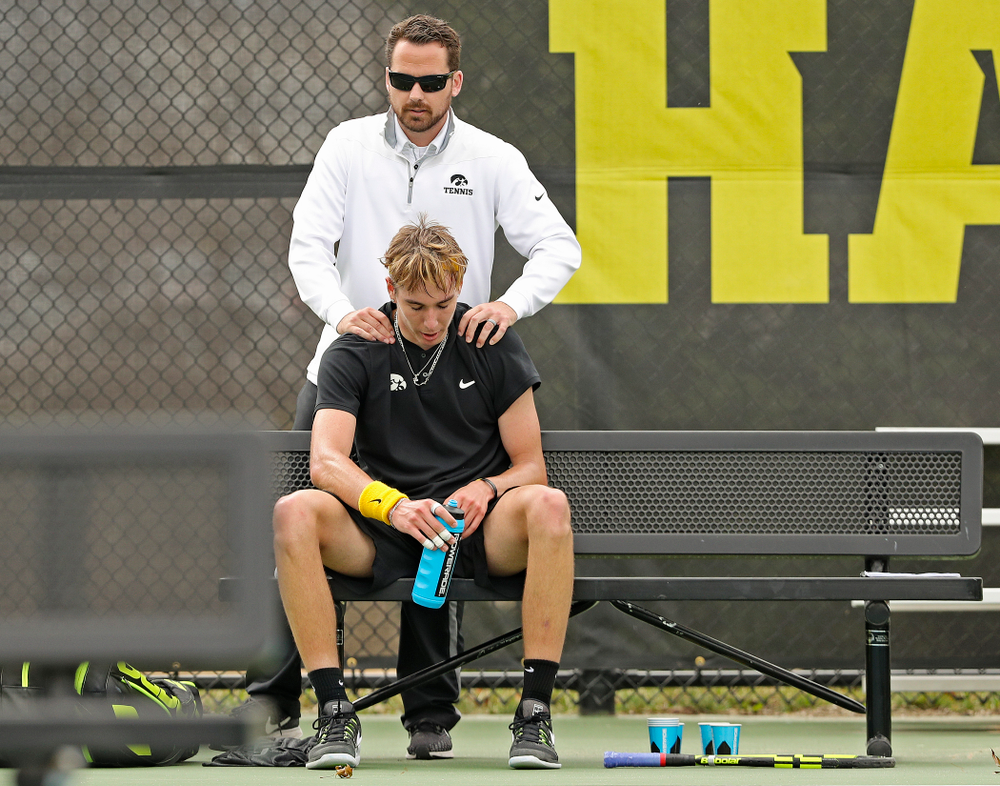Iowa head coach Ross Wilson (top) talks with Nikita Snezhko during a match against Ohio State at the Hawkeye Tennis and Recreation Complex in Iowa City on Sunday, Apr. 7, 2019. (Stephen Mally/hawkeyesports.com)