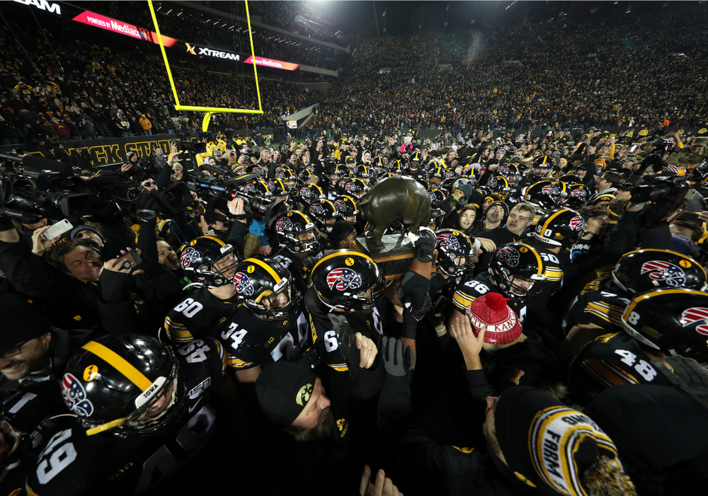 The Iowa Hawkeyes celebrate with the Floyd of Rosedale Trophy following their 23-19 victory over the Minnesota Golden Gophers Saturday, November 16, 2019 at Kinnick Stadium. (Brian Ray/hawkeyesports.com)