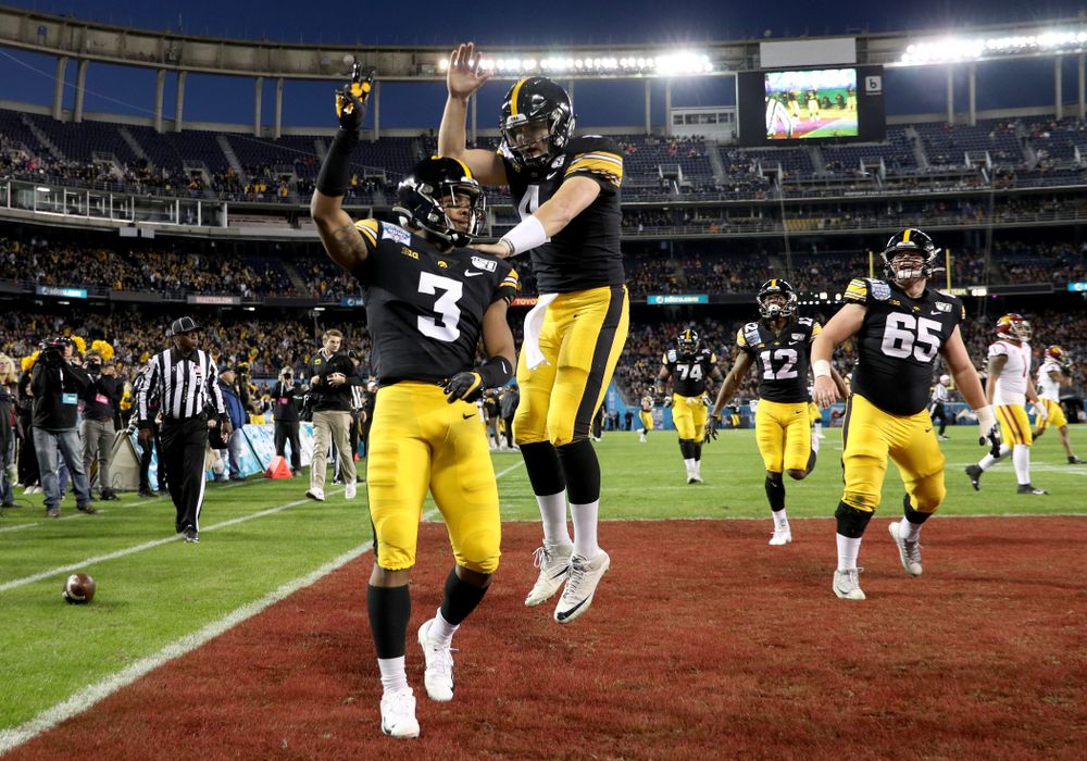 Iowa Hawkeyes wide receiver Tyrone Tracy Jr. (3) and quarterback Nate Stanley (4) celebrate after scoring against USC in the Holiday Bowl Friday, December 27, 2019 at San Diego Community Credit Union Stadium. (Brian Ray/hawkeyesports.com)