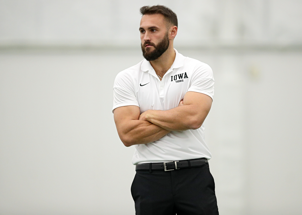 Iowa assistant coach Lloyd Bruce-Burgess looks on during their match at the Hawkeye Tennis and Recreation Complex in Iowa City on Thursday, January 16, 2020. (Stephen Mally/hawkeyesports.com)