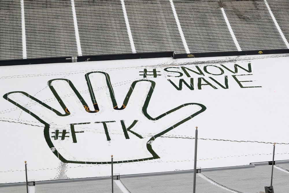 Members of the Iowa Athletics Turf Management staff create the #SnowWave for kids in the Stead Family Children's Hospital Thursday, February