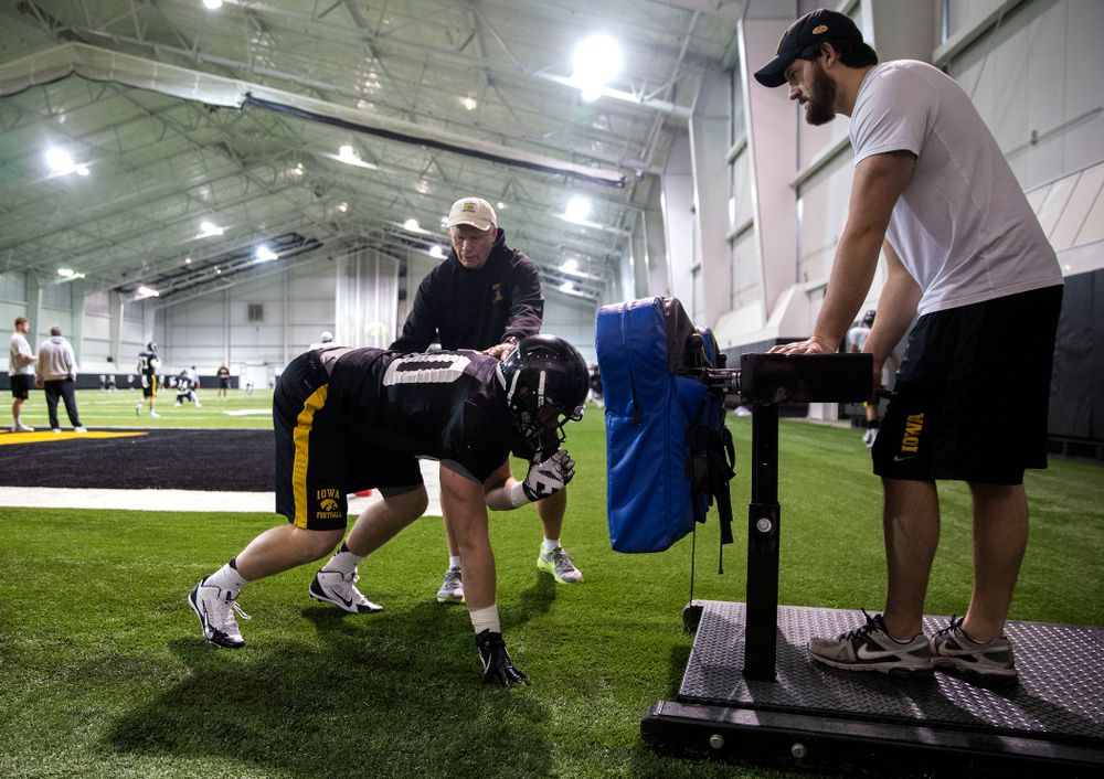 Iowa Hawkeyes defensive line coach Reese Morgan works with linebacker Parker Hesse (40) during their third bowl practice Friday, Dec. 19, 2014 in the indoor practice facility. (Brian Ray/hawkeyesports.com)