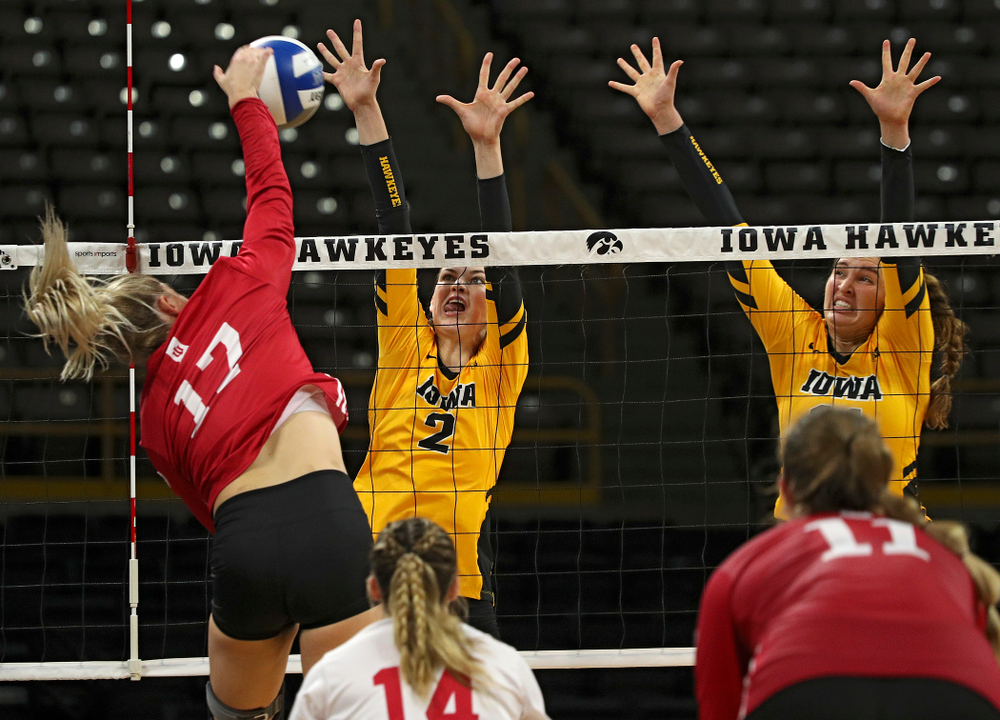 Iowa’s Courtney Buzzerio (2) and Blythe Rients (11) try for a block during their match at Carver-Hawkeye Arena in Iowa City on Sunday, Oct 20, 2019. (Stephen Mally/hawkeyesports.com)