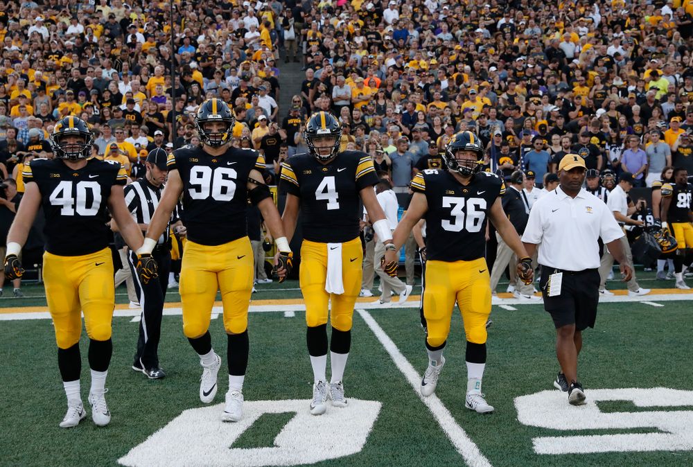 Captains Iowa Hawkeyes defensive end Parker Hesse (40), defensive end Matt Nelson (96), quarterback Nate Stanley (4), fullback Brady Ross (36) and honorary captain Marvin Sims, Jr. against the Northern Iowa Panthers Saturday, September 15, 2018 at Kinnick Stadium. (Brian Ray/hawkeyesports.com)