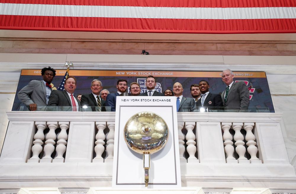 Iowa Hawkeyes linebacker Josey Jewell (43), defensive back Joshua Jackson (15), offensive lineman Sean Welsh (79) and head coach Kirk Ferentz ring the opening bell at the New York Stock Exchange Tuesday, December 26, 2017 in New York. (Brian Ray/hawkeyesports.com)