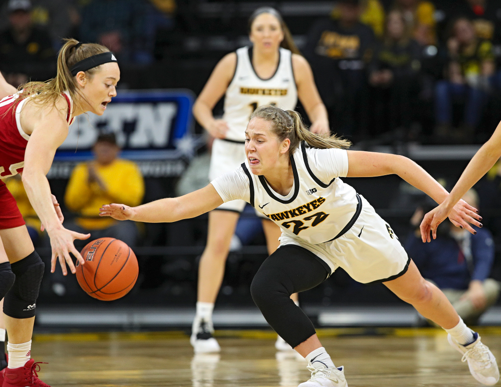 Iowa Hawkeyes guard Kathleen Doyle (22) tries to knock the ball away from Indiana Hoosiers forward Brenna Wise (50) during the first quarter of their game at Carver-Hawkeye Arena in Iowa City on Sunday, January 12, 2020. (Stephen Mally/hawkeyesports.com)