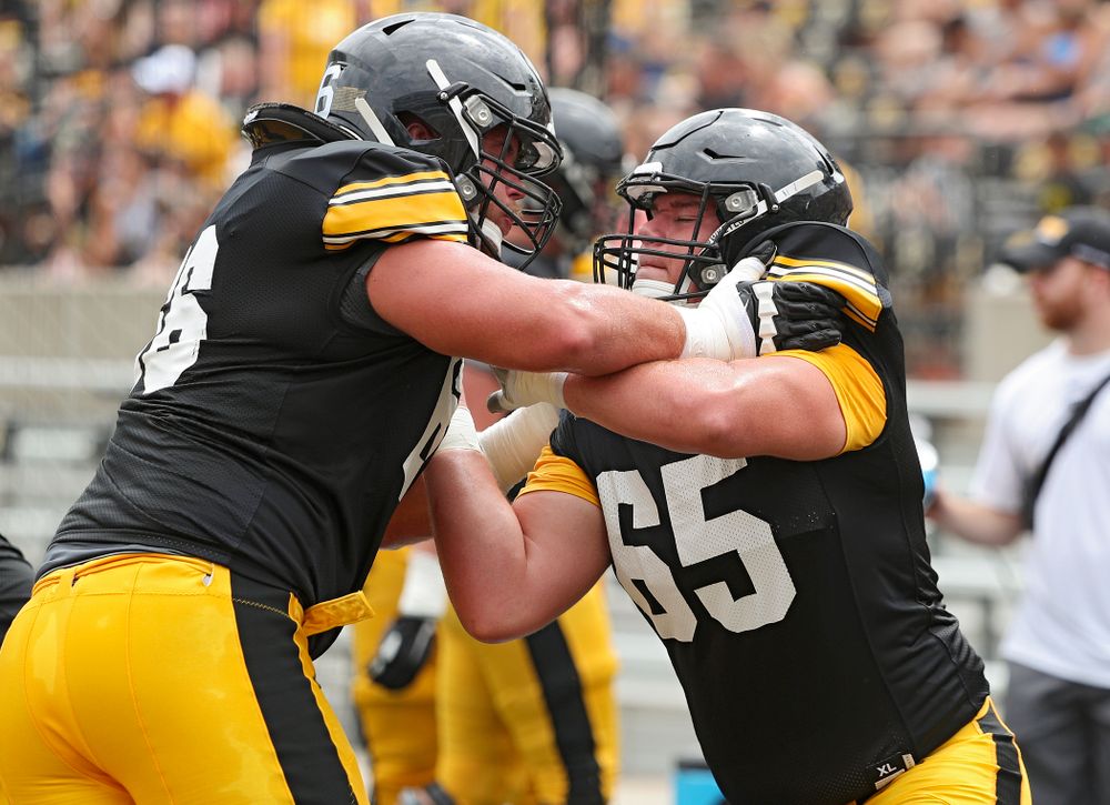 Iowa Hawkeyes offensive lineman Levi Paulsen (66) and offensive lineman Tyler Linderbaum (65) work on a drill during Fall Camp Practice No. 8 at Kids Day at Kinnick Stadium in Iowa City on Saturday, Aug 10, 2019. (Stephen Mally/hawkeyesports.com)
