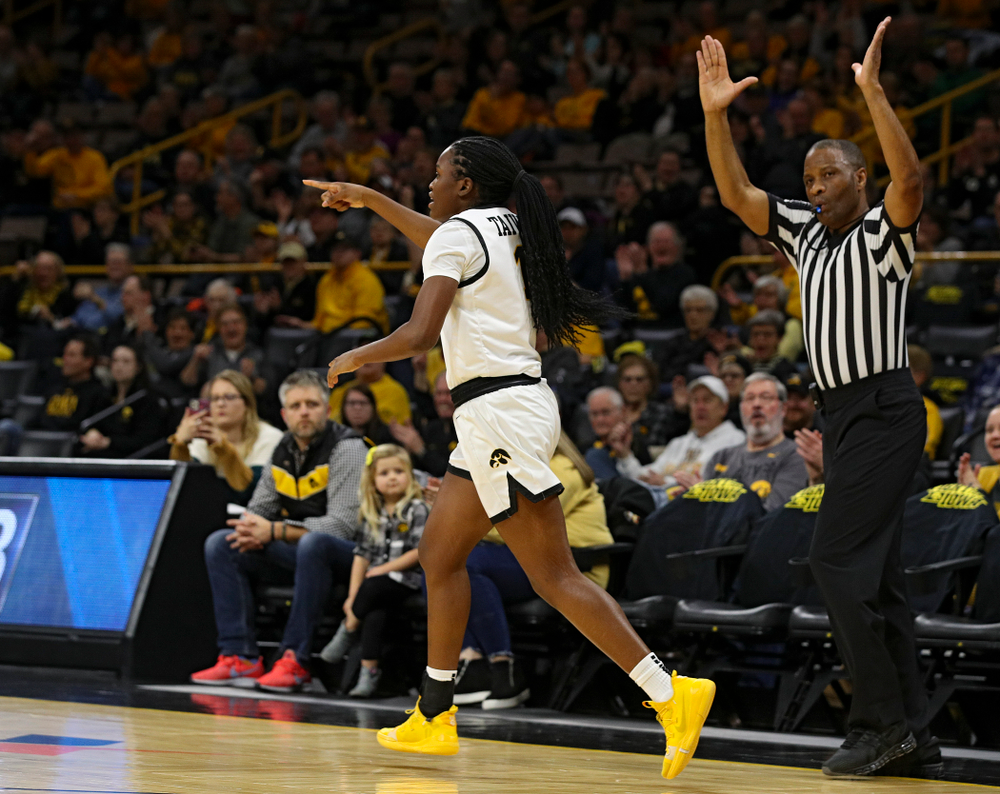 Iowa Hawkeyes guard Tomi Taiwo (1) points after making a 3-pointer during the first quarter of their game at Carver-Hawkeye Arena in Iowa City on Tuesday, December 31, 2019. (Stephen Mally/hawkeyesports.com)