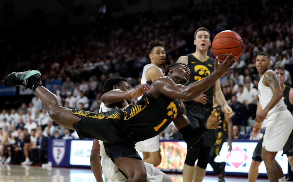 Iowa Hawkeyes guard Joe Toussaint (1) draws a foul against Penn State Saturday, January 4, 2020 at the Palestra in Philadelphia. (Brian Ray/hawkeyesports.com)