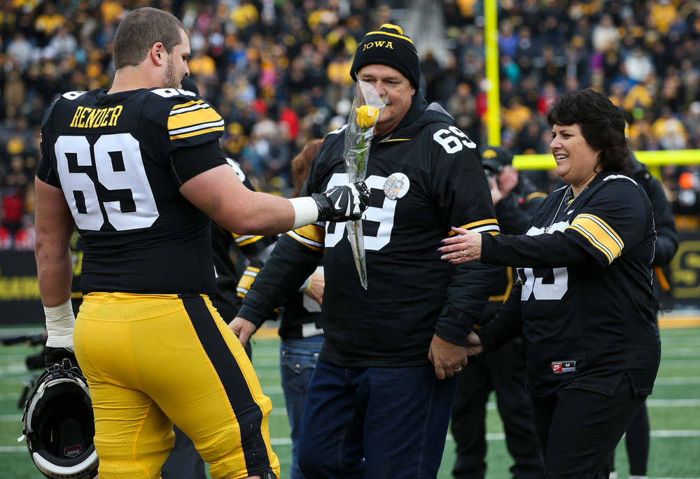 Iowa Hawkeyes offensive lineman Keegan Render (69) is greeted by his parents during Senior Day ceremonies before a game against Nebraska at Kinnick Stadium on November 23, 2018. (Tork Mason/hawkeyesports.com)