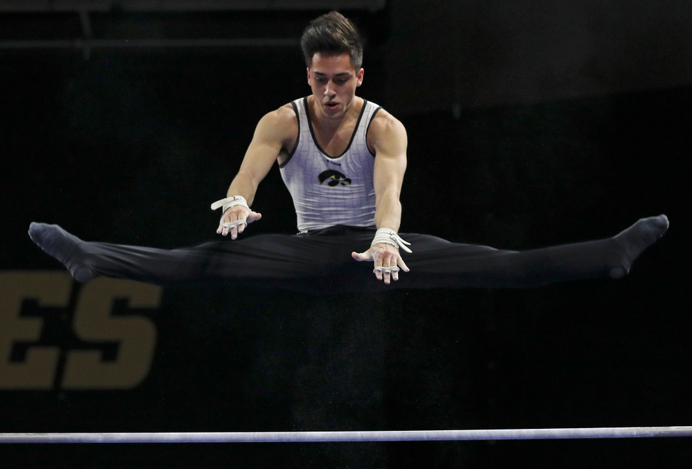 Iowa's Andrew Herrador competes in the parallel bars during the second day of the Big Ten Men's Gymnastics Championships at Carver-Hawkeye Arena in Iowa City on Saturday, Apr. 6, 2019. (Stephen Mally/hawkeyesports.com)