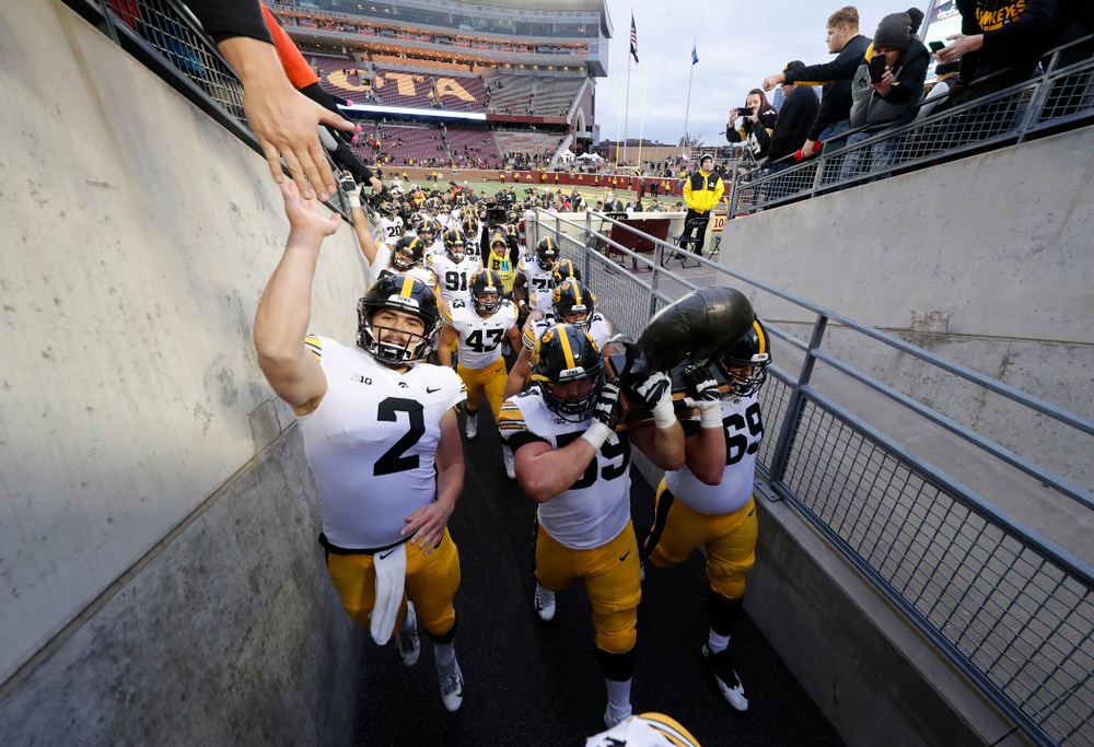 The Iowa Hawkeyes celebrate with the Floyd of Rosedale trophy following their win over the Minnesota Golden Gophers Saturday, October 6, 2018 at TCF Bank Stadium. (Brian Ray/hawkeyesports.com)