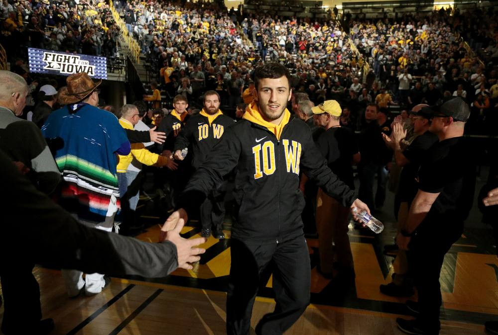 Michael Kemerer slaps hands in the alumni tunnel before the Iowa Hawkeyes meet against Oklahoma State’s at pounds Sunday, February 23, 2020 at Carver-Hawkeye Arena. (Brian Ray/hawkeyesports.com)