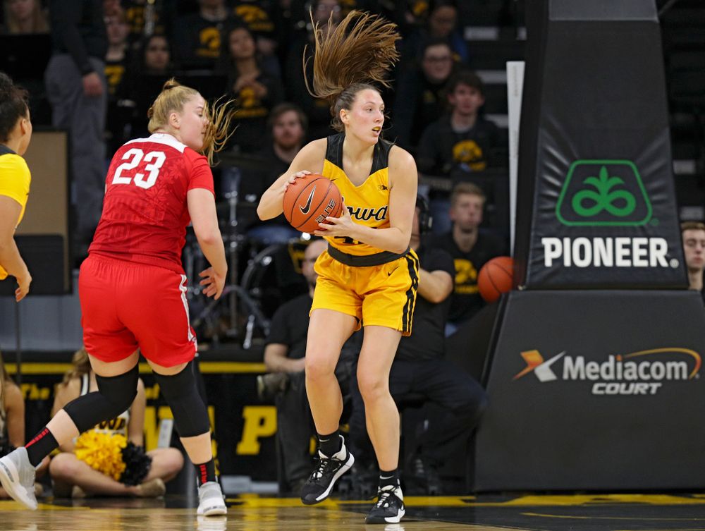 Iowa Hawkeyes forward Amanda Ollinger (43) looks to pass after blocking a shot by Ohio State Buckeyes forward Rebeka Mikulasikova (23) during the third quarter of their game at Carver-Hawkeye Arena in Iowa City on Thursday, January 23, 2020. (Stephen Mally/hawkeyesports.com)