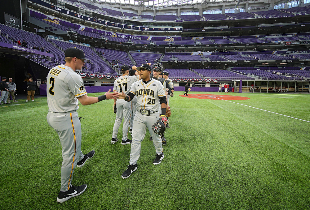 Iowa Hawkeyes infielder Brendan Sher (2) and infielder Izaya Fullard (20) greet each other after warming up before their CambriaCollegeClassic game at U.S. Bank Stadium in Minneapolis, Minn. on Friday, February 28, 2020. (Stephen Mally/hawkeyesports.com)