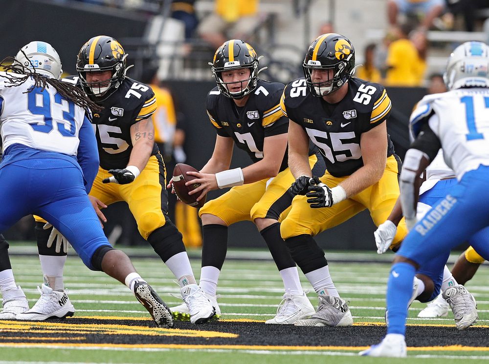 Iowa Hawkeyes quarterback Spencer Petras (7) takes a snap from offensive lineman Jeff Jenkins (75) during fourth quarter of their game at Kinnick Stadium in Iowa City on Saturday, Sep 28, 2019. (Stephen Mally/hawkeyesports.com)