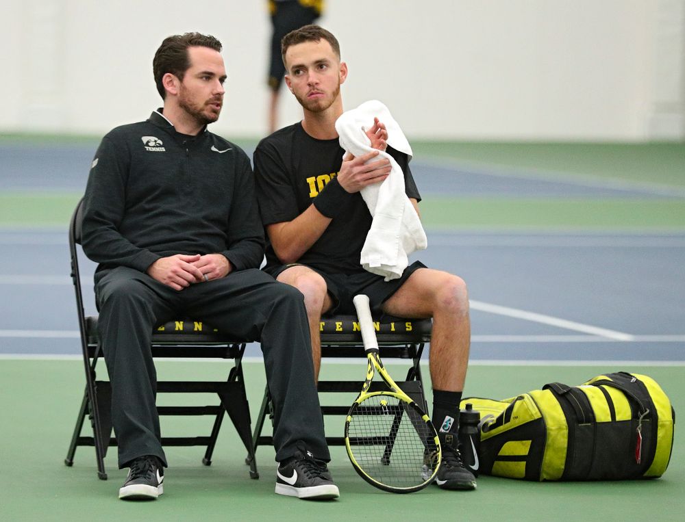 Mellecker Family Head Men's Tennis Coach Ross Wilson (from left) talks with Kareem Allaf during his singles match at the Hawkeye Tennis and Recreation Complex in Iowa City on Friday, February 14, 2020. (Stephen Mally/hawkeyesports.com)