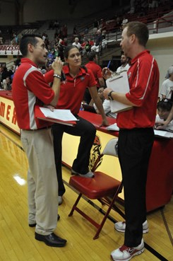 Assistant coaches Lisa Beauchene and Ben Wallis consult with volunteer assistant Doug Manning following the MCM Elegante Lobo Classic championship...