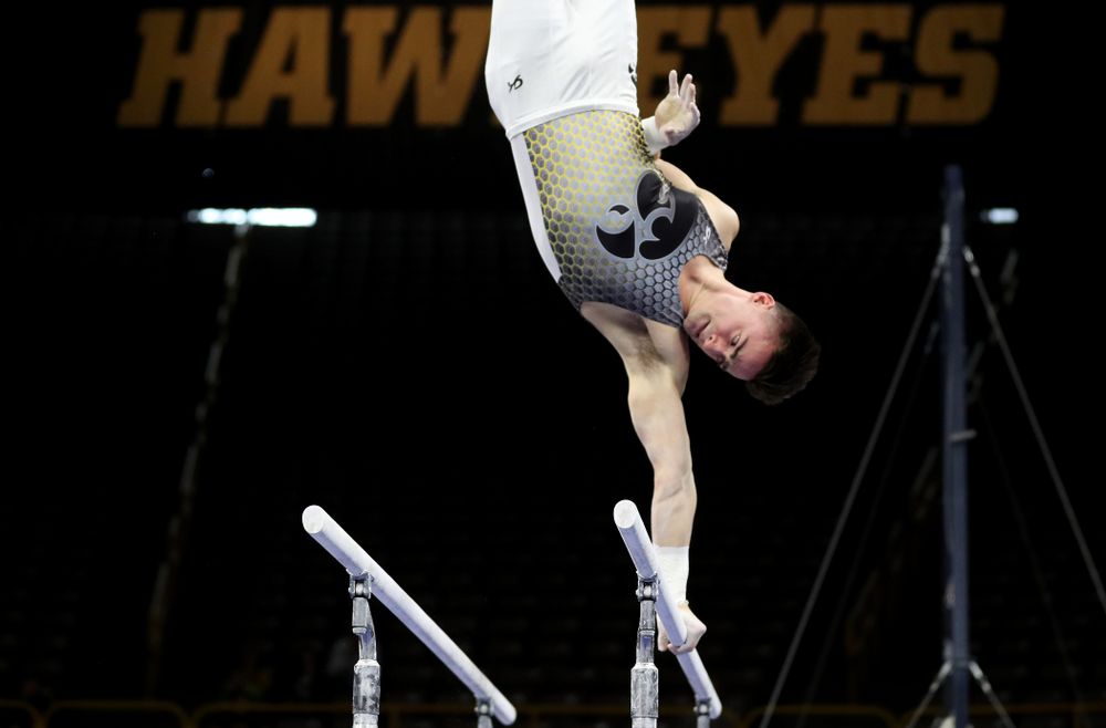 Iowa’s Mitch Mandozzi competes on the parallel bars against Illinois Sunday, March 1, 2020 at Carver-Hawkeye Arena. (Brian Ray/hawkeyesports.com)