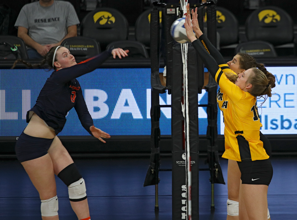 Iowa’s Hannah Clayton (18) and Blythe Rients (11) block a shot during the second set of their match against Illinois at Carver-Hawkeye Arena in Iowa City on Wednesday, Nov 6, 2019. (Stephen Mally/hawkeyesports.com)