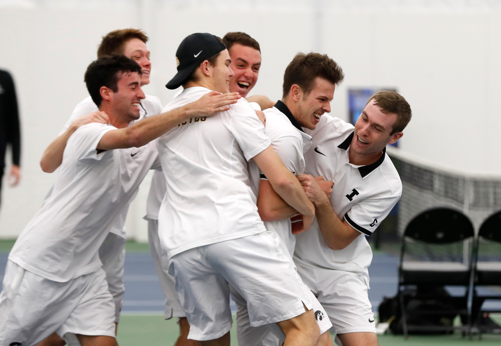 Iowa's Piotr Smietana celebrates with his teammates after clinching the match against Purdue Sunday, April 15, 2018 at the Hawkeye Tennis an