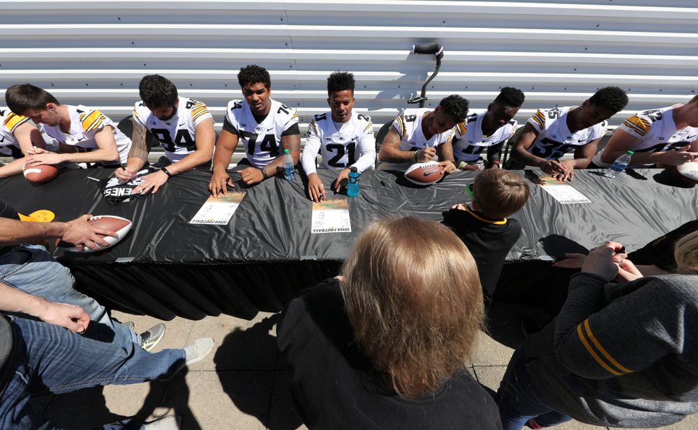Members of the Iowa Football team sign autographs before the Iowa Hawkeyes game against the Nebraska Cornhuskers Saturday, April 20, 2019 at Duane Banks Field. (Brian Ray/hawkeyesports.com)