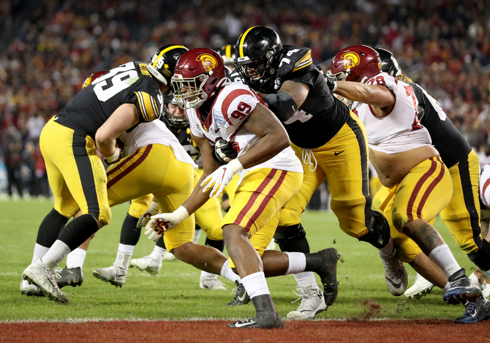 Iowa Hawkeyes offensive lineman Tristan Wirfs (74) blocks as running back Tyler Goodson (15) scores against USC in the Holiday Bowl Friday, December 27, 2019 at San Diego Community Credit Union Stadium. (Brian Ray/hawkeyesports.com)