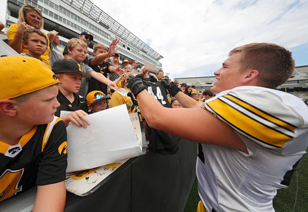 Iowa Hawkeyes linebacker Seth Benson (44) hands back an autographed #44 jersey during Kids Day at Kinnick Stadium in Iowa City on Saturday, Aug 10, 2019. (Stephen Mally/hawkeyesports.com)