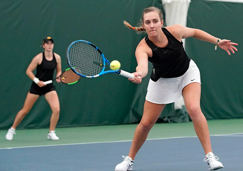 Iowa's Ashleigh Jacobs (right) returns a shot as Elise van Heuvelen Treadwell (left) looks on during their doubles match against Indiana at the Hawkeye Tennis and Recreation Complex in Iowa City on Sunday, Mar. 31, 2019. (Stephen Mally/hawkeyesports.com)