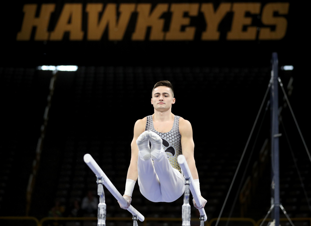 Iowa’s Mitch Mandozzi competes on the parallel bars against Illinois Sunday, March 1, 2020 at Carver-Hawkeye Arena. (Brian Ray/hawkeyesports.com)