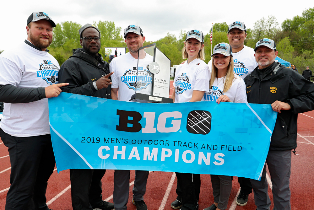 Iowa assistant coach Eric Werskey (from left), assistant coach Clive Roberts, Director of Track and Field Joey Woody, director of operations Kate Wakenight, assistant coach Paige Knodle, assistant coach Jason Wakenight, and associate head coach Randy Hasenbank after winning the Men's Big Ten Outdoor Track and Field Championships on the third day of the Big Ten Outdoor Track and Field Championships at Francis X. Cretzmeyer Track in Iowa City on Sunday, May. 12, 2019. (Stephen Mally/hawkeyesports.com)