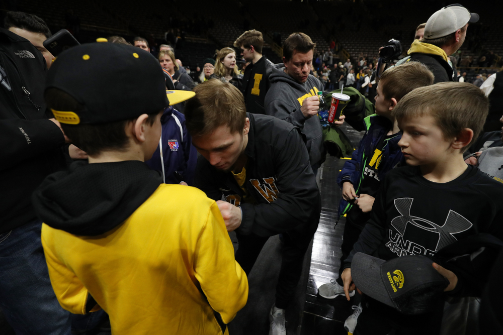 Iowa's Spencer Lee signs autographs following their meet against the Indiana Hoosiers Friday, February 15, 2019 at Carver-Hawkeye Arena. (Brian Ray/hawkeyesports.com)