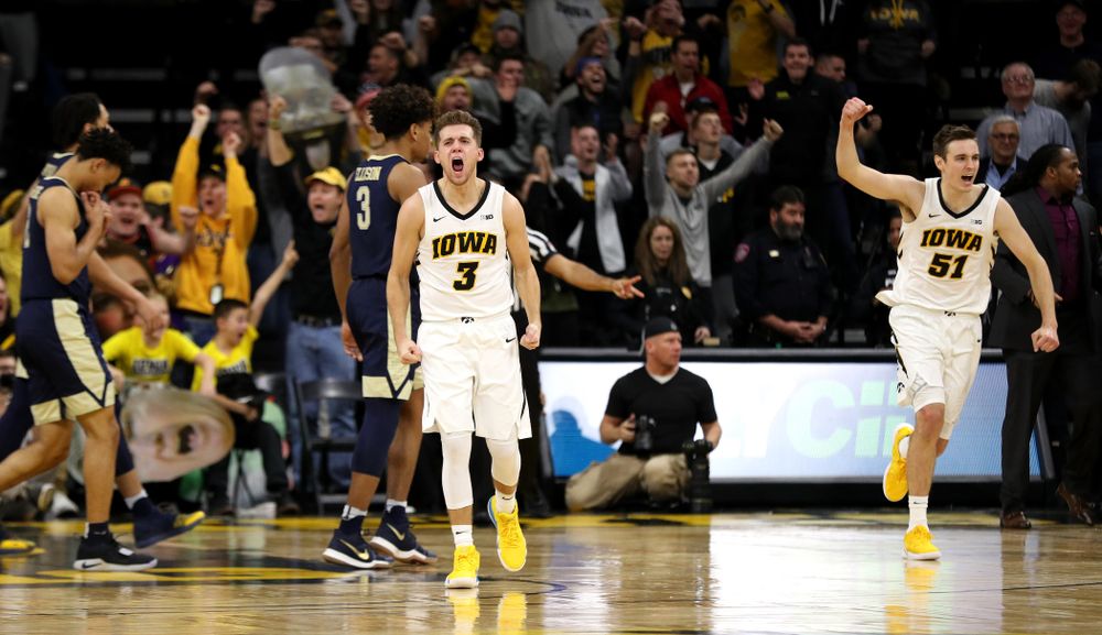 Iowa Hawkeyes guard Jordan Bohannon (3) and forward Nicholas Baer (51) celebrate their victory against the Pitt Panthers Tuesday, November 27, 2018 at Carver-Hawkeye Arena. (Brian Ray/hawkeyesports.com)