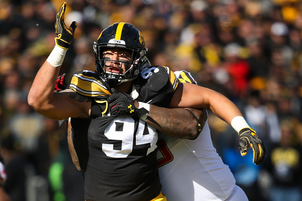 Iowa Hawkeyes defensive end A.J. Epenesa (94) is held while rushing the quarterback during a game against Maryland at Kinnick Stadium on October 20, 2018. (Tork Mason/hawkeyesports.com)