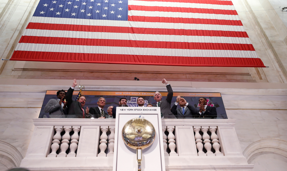 Iowa Hawkeyes linebacker Josey Jewell (43), defensive back Joshua Jackson (15), offensive lineman Sean Welsh (79) and head coach Kirk Ferentz ring the opening bell at the New York Stock Exchange Tuesday, December 26, 2017 in New York. (Brian Ray/hawkeyesports.com)