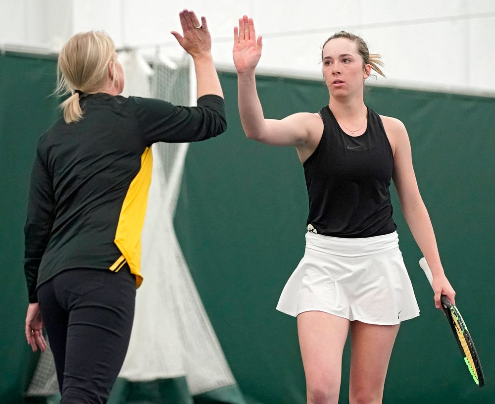 Iowa head coach Sasha Schmid gives a high-five to Samantha Mannix during a match against Indiana at the Hawkeye Tennis and Recreation Complex in Iowa City on Sunday, Mar. 31, 2019. (Stephen Mally/hawkeyesports.com)