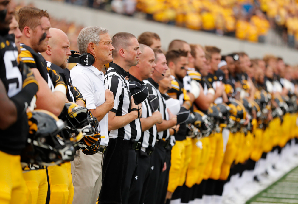 Iowa Hawkeyes head coach Kirk Ferentz stands for the National Anthem against the Northern Illinois Huskies Saturday, September 1, 2018 at Kinnick Stadium. (Brian Ray/hawkeyesports.com)