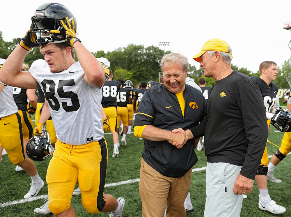 University of Iowa President Bruce Harreld and Iowa Hawkeyes head coach Kirk Ferentz shake hands during Fall Camp Practice No. 10 at the Hansen Football Performance Center in Iowa City on Tuesday, Aug 13, 2019. (Stephen Mally/hawkeyesports.com)