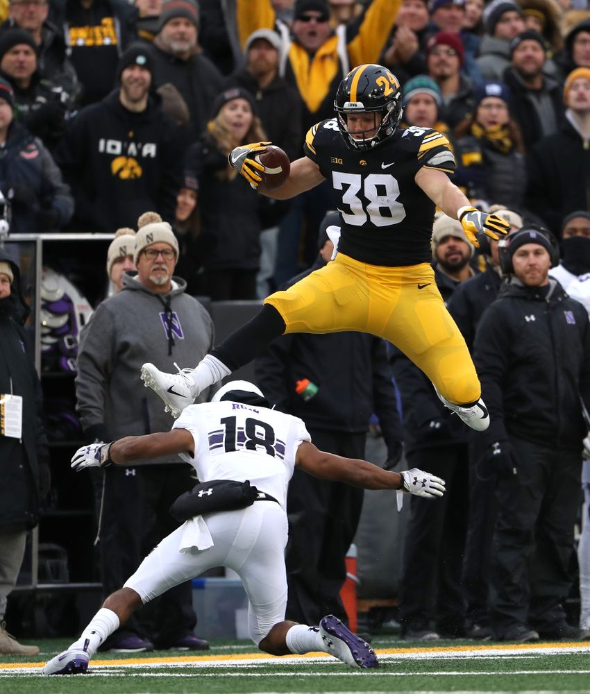 Iowa Hawkeyes tight end T.J. Hockenson (38) hurdles a defender against the Northwestern Wildcats Saturday, November 10, 2018 at Kinnick Stadium. (Brian Ray/hawkeyesports.com)