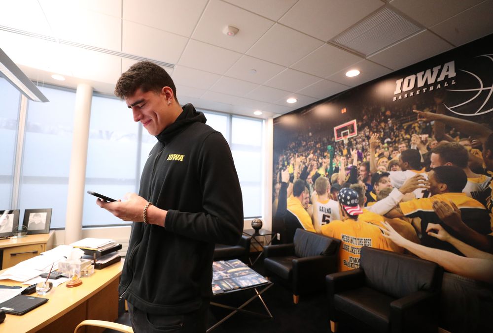 Iowa Hawkeyes forward Luka Garza (55) calls his dad after finding out that he has been named the Big Ten Player of the Year Monday, March 9, 2020 at Carver-Hawkeye Arena. (Brian Ray/hawkeyesports.com)