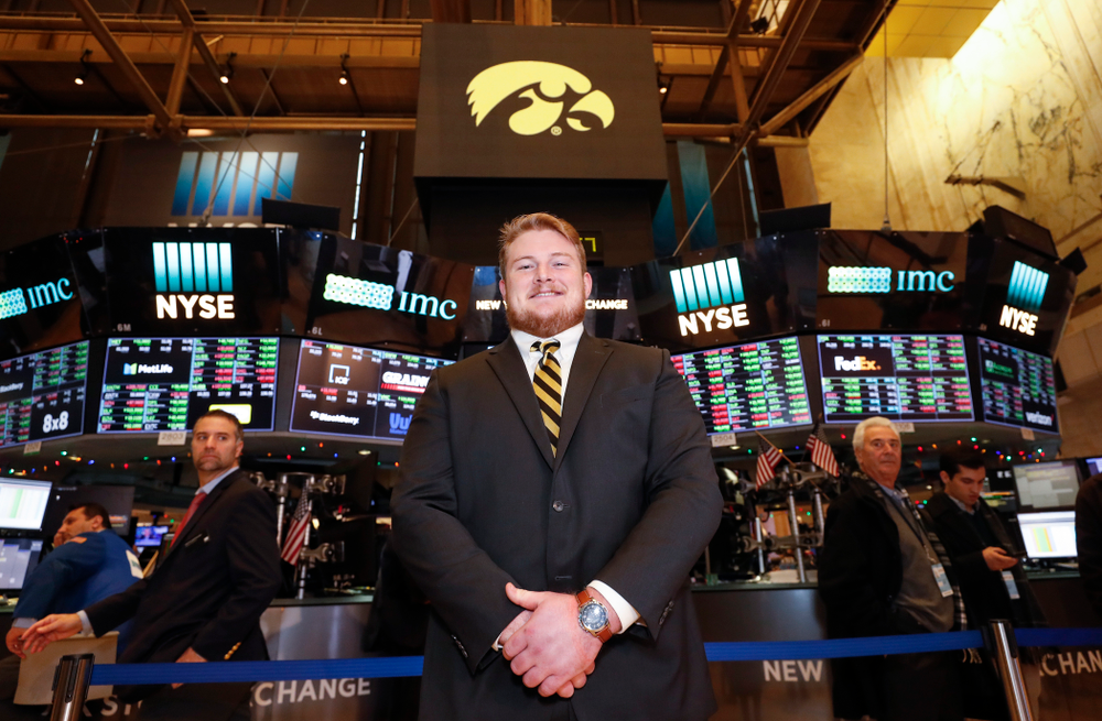 Iowa Hawkeyes linebacker Josey Jewell (43), defensive back Joshua Jackson (15), offensive lineman Sean Welsh (79) and head coach Kirk Ferentz ring the opening bell at the New York Stock Exchange Tuesday, December 26, 2017 in New York. (Brian Ray/hawkeyesports.com)