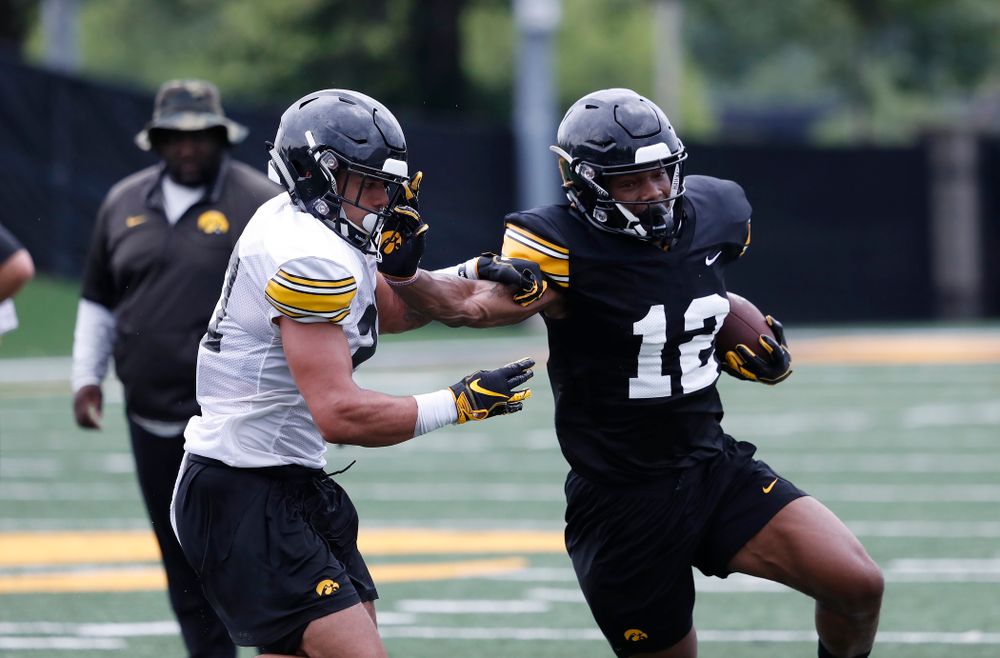 Iowa Hawkeyes wide receiver Brandon Smith (12) and defensive back Amani Hooker (27) during practice No. 4 of Fall Camp Monday, August 6, 2018 at the Hansen Football Performance Center. (Brian Ray/hawkeyesports.com)