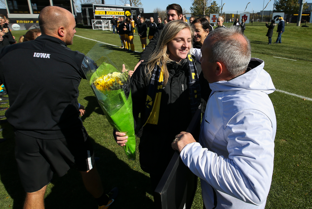 Iowa Hawkeyes head coach Dave DiIanni hugs Iowa Hawkeyes midfielder Jenna Kentgen (8) during Senior Day ceremonies before a game against Northwestern at the Iowa Soccer Complex on October 21, 2018. (Tork Mason/hawkeyesports.com)