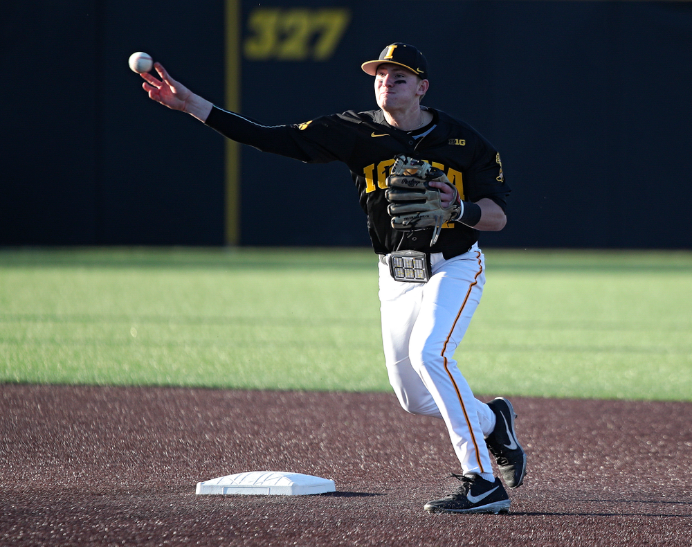 Iowa infielder Brendan Sher (2) throws to first to complete a double play during the third inning of their game at Duane Banks Field in Iowa City on Tuesday, March 3, 2020. (Stephen Mally/hawkeyesports.com)